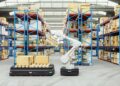 Modern automated warehouse with AGV robots navigating between high-density shelving units