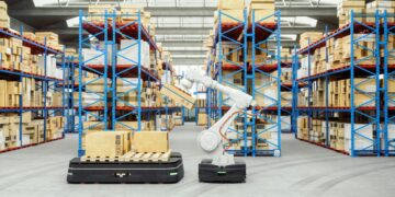 Modern automated warehouse with AGV robots navigating between high-density shelving units