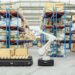 Modern automated warehouse with AGV robots navigating between high-density shelving units
